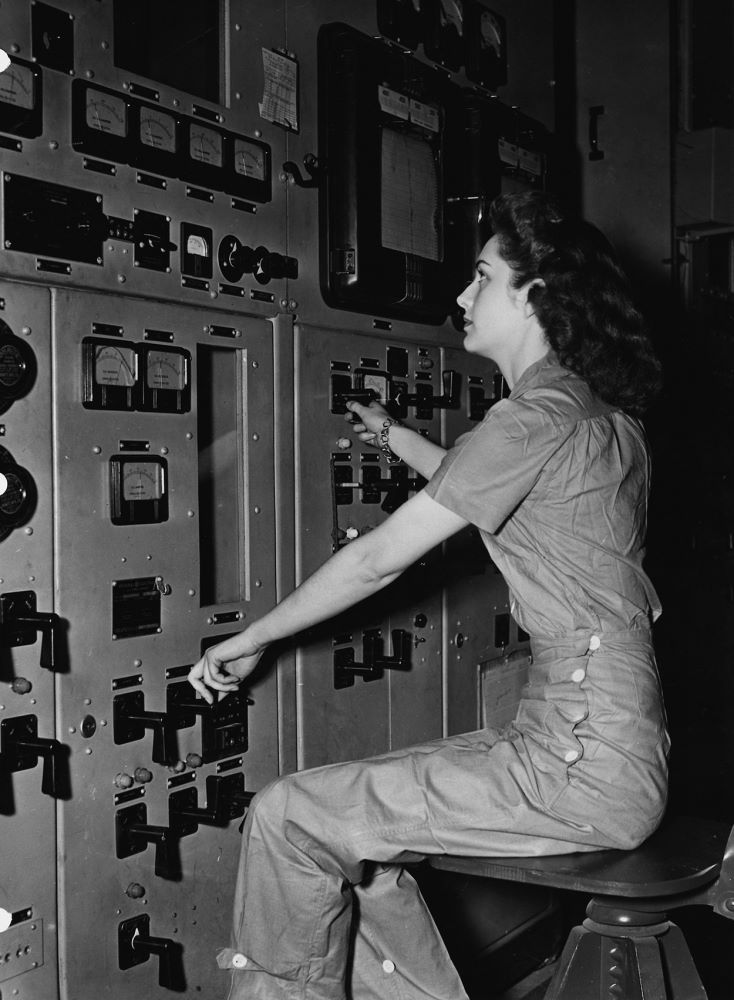 Calutron Girl monitoring gauges and adjusting various controls